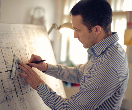 Man working on a construction blue print