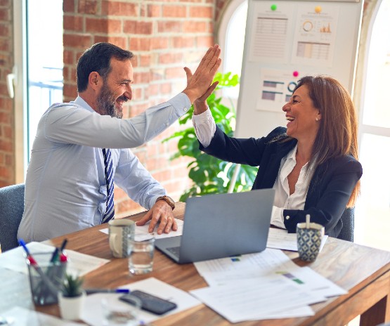 Coworkers high-fiving 