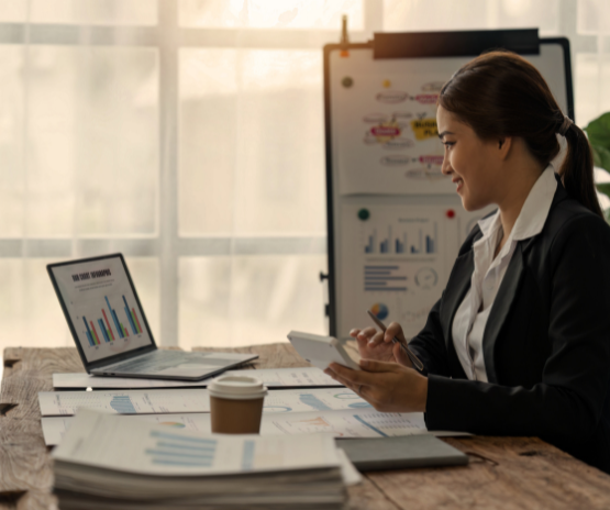 Business woman sitting at her computer crunching numbers