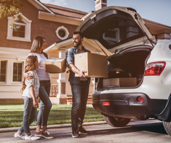 Family loading up their car with boxes