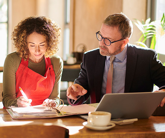 Two business professionals going over paperwork