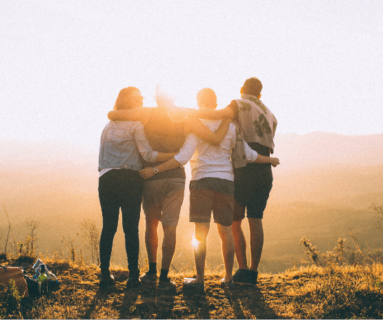 People embracing on a hill top