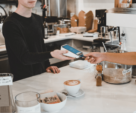 Person paying at a coffee shop