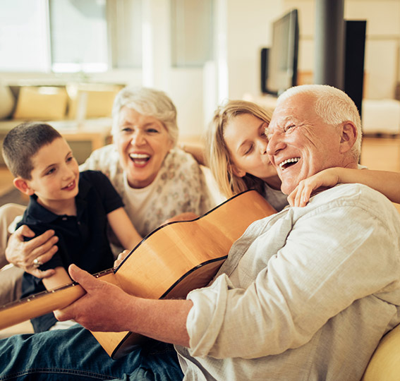 Children and grandparents singing in living room